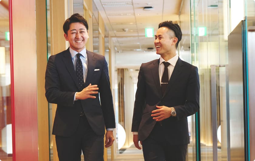 男性社員同士が仲良さそうに会話している様子